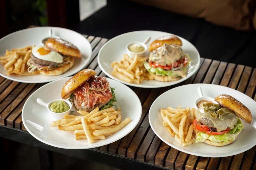 four specialty burgers on plates best restaurants in temecula ca