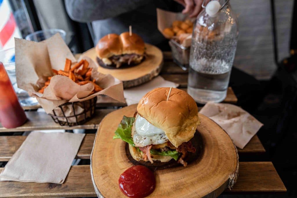 burger on plate with fries best restaurants in huntington beach