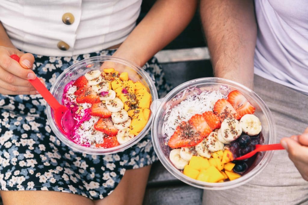 people holding acai bowls with fruit on top best restaurants in laguna niguel