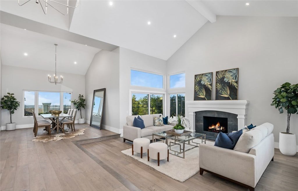 Living room with vaulted ceilings, recessed lighting and brand new flooring