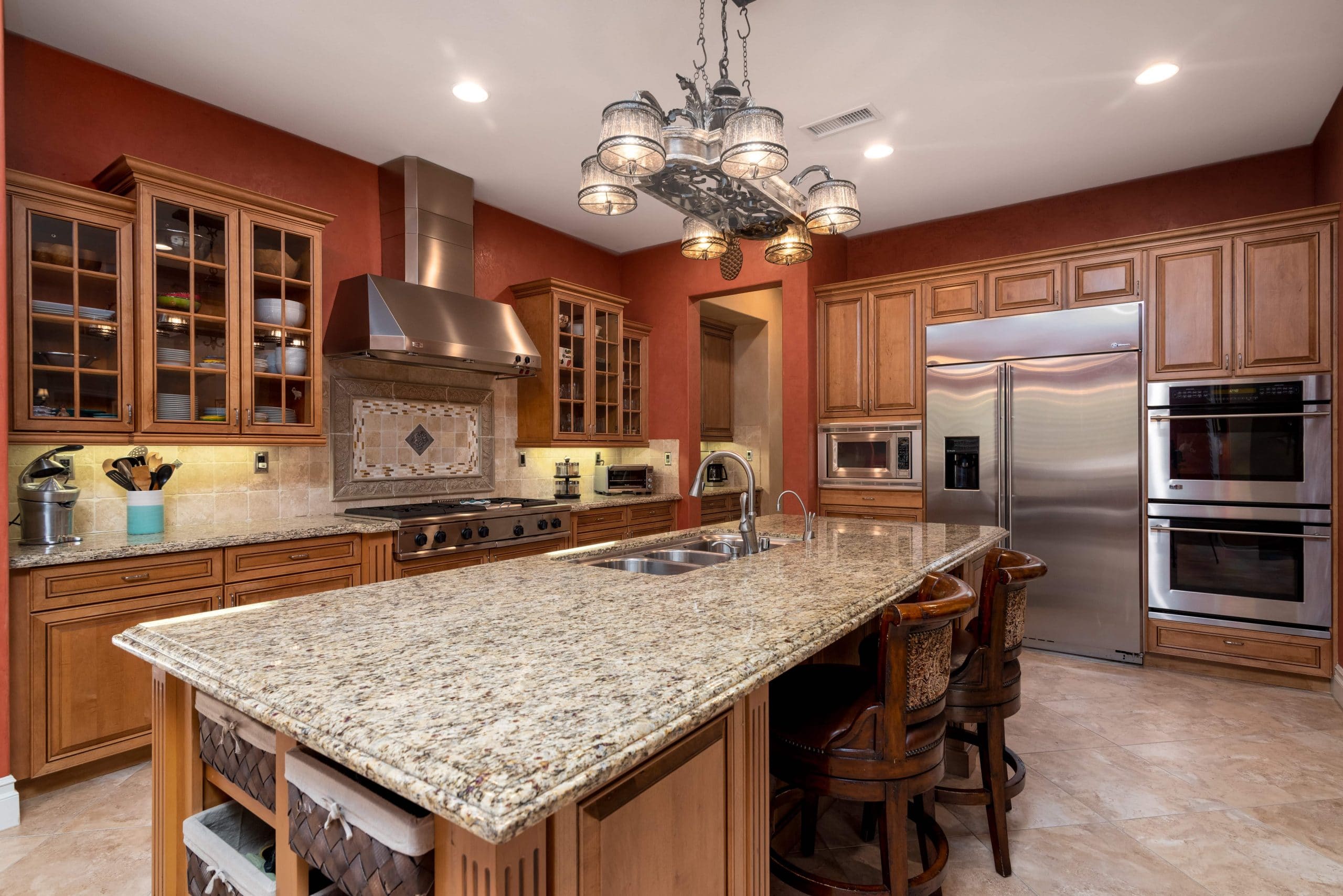 Kitchen with large center island and stainless steel hood range