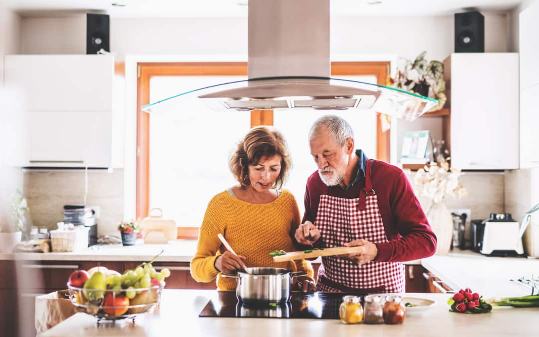 Senior couple preparing food in the kitchen