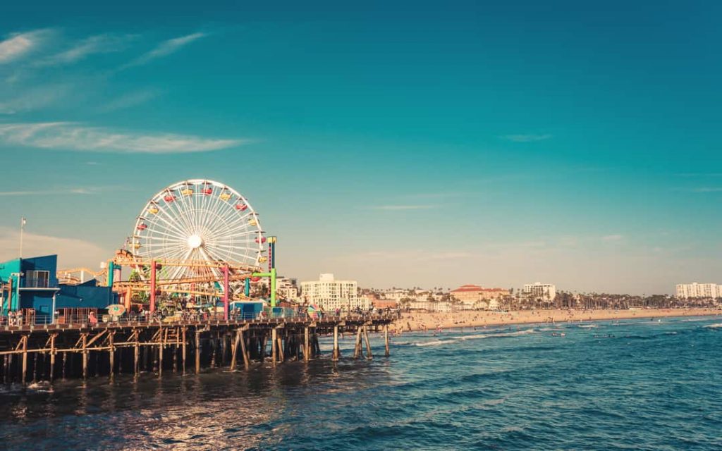 Famous Santa Monica Ferris Wheel Amusement Park In Sunset Ligh